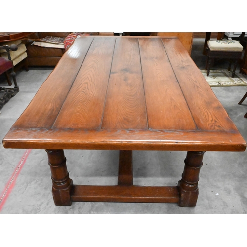 352 - A good quality oak refectory style dining table with cleated five-plank top raised on turned legs un... 