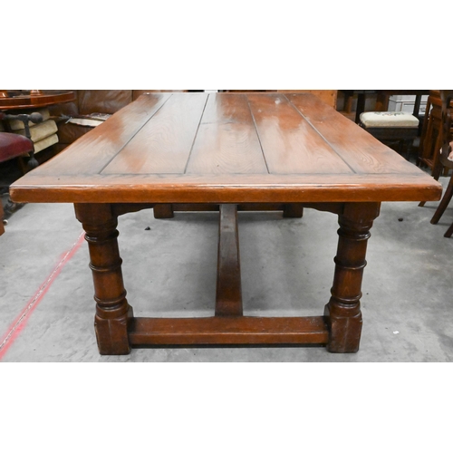 352 - A good quality oak refectory style dining table with cleated five-plank top raised on turned legs un... 