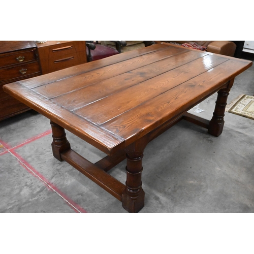 352 - A good quality oak refectory style dining table with cleated five-plank top raised on turned legs un... 