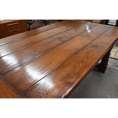 352 - A good quality oak refectory style dining table with cleated five-plank top raised on turned legs un... 