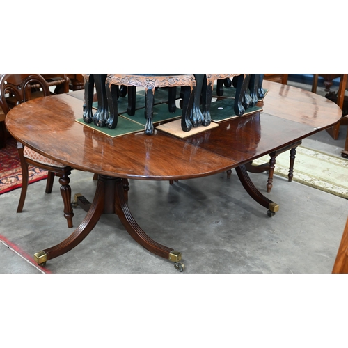 358 - A Regency style mahogany extending dining table with single central leaf on twin pedestal supports, ... 