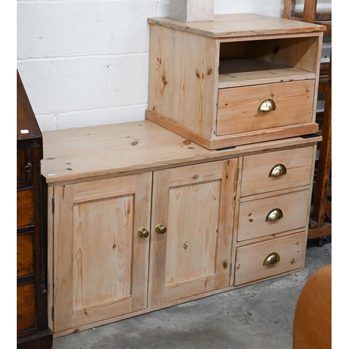 371 - A stripped pine side cabinet with panelled doors and three drawers with brass handles, 122 x 30 x 60... 