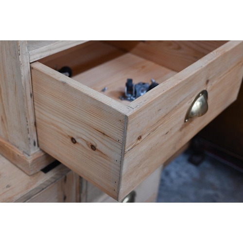 371 - A stripped pine side cabinet with panelled doors and three drawers with brass handles, 122 x 30 x 60... 