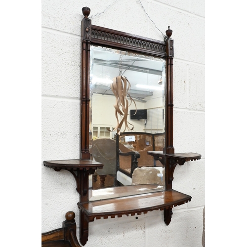 377 - A bevelled wall mirror in fret-cut simulated bamboo frame with three shelves in Chippendale manner, ... 