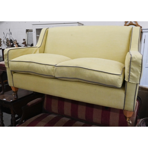 378 - A two-seater Kersey sofa with woven lime fabric and brown piping, light oak tapering square supports... 