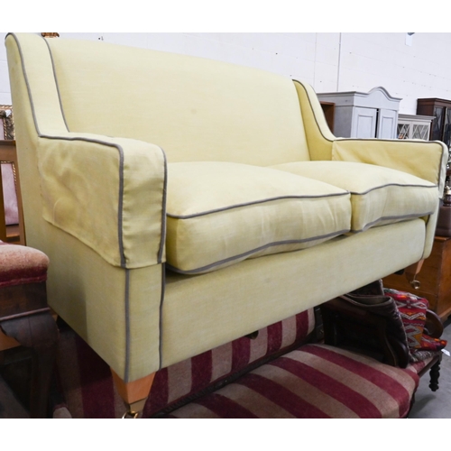 378 - A two-seater Kersey sofa with woven lime fabric and brown piping, light oak tapering square supports... 