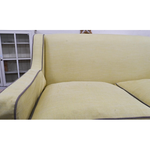 378 - A two-seater Kersey sofa with woven lime fabric and brown piping, light oak tapering square supports... 