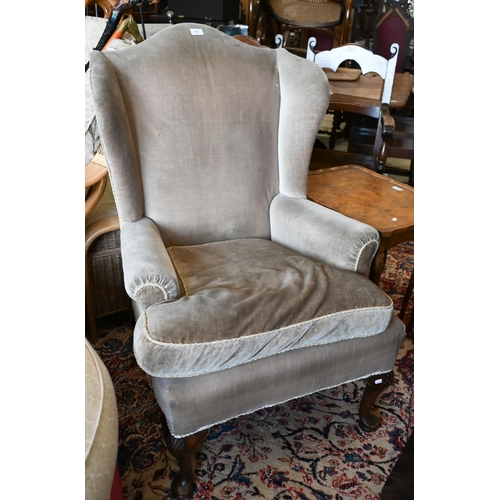 398 - A walnut framed Georgian style wingback armchair, brown dralon upholstery