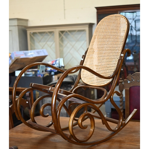 402 - A Thonet style bentwood rocking chair with cane worked back and seat