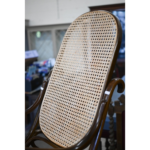 402 - A Thonet style bentwood rocking chair with cane worked back and seat