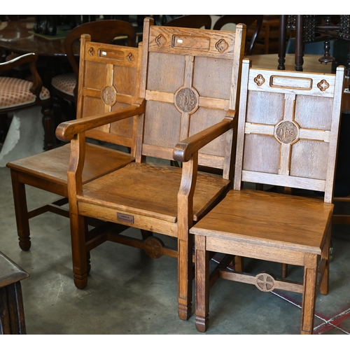 410 - A panelled oak church armchair to/w pair of matching side chairs, with inscription 'IHS' (3)