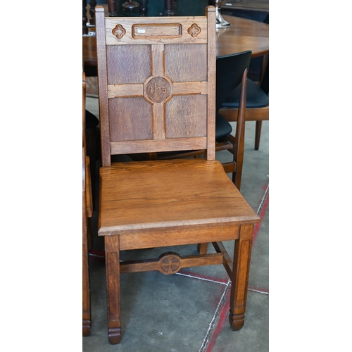 410 - A panelled oak church armchair to/w pair of matching side chairs, with inscription 'IHS' (3)