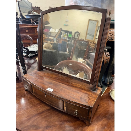 414 - A 19th century mahogany toilet mirror on bowfront three drawer platform base