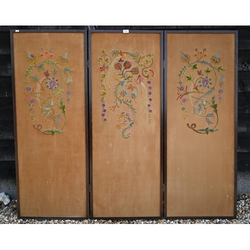 415 - A three-panel folding screen with floral crewel embroidery, 156 cm wide x 135 cm high overall