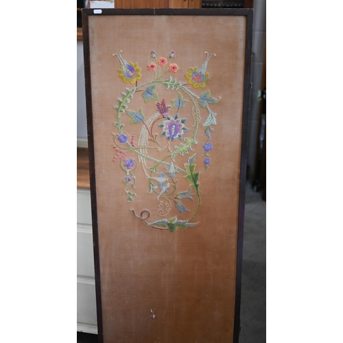 415 - A three-panel folding screen with floral crewel embroidery, 156 cm wide x 135 cm high overall