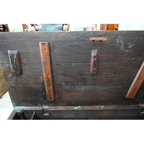 422 - An antique panelled oak coffer, 122 cm wide x 58 cm deep x 66 cm high