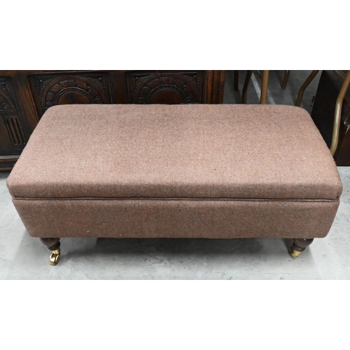 427 - Rectangular footstool, brown tweed upholstery on turned legs with brass castors, 90 x 40 x 38 cm h