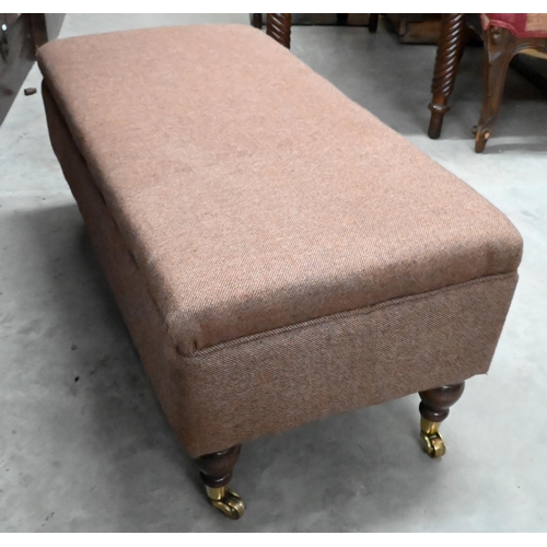 427 - Rectangular footstool, brown tweed upholstery on turned legs with brass castors, 90 x 40 x 38 cm h