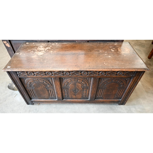 428 - A panelled oak coffer, triple arcade carved front, on modern castors, 115 x 45 x 56 cm h 