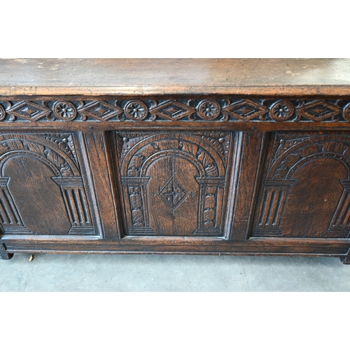 428 - A panelled oak coffer, triple arcade carved front, on modern castors, 115 x 45 x 56 cm h 