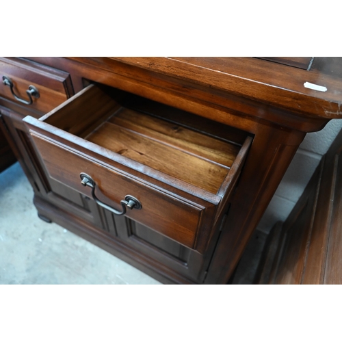 438 - A modern hardwood (Oak Furniture Land, Cranbrook) dresser with four drawers and panelled cupboards, ... 