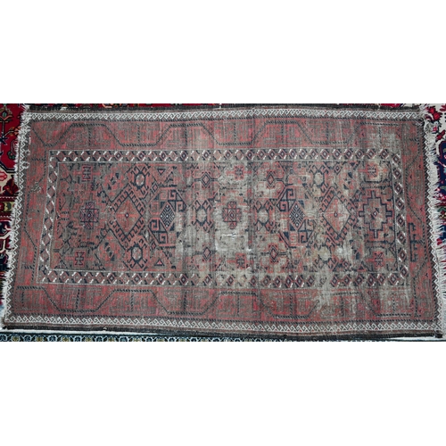 444 - A worn Persian red and brown Balouch rug, 178 x 100 cm