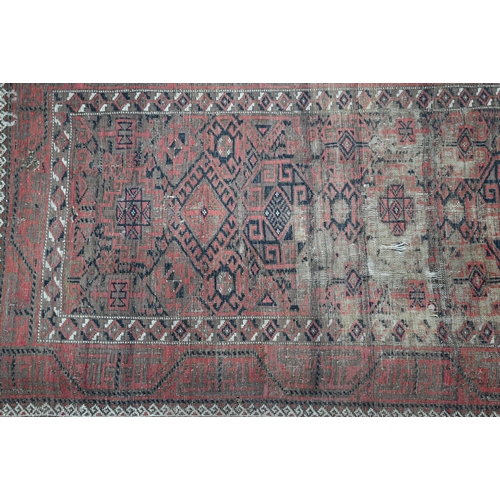 444 - A worn Persian red and brown Balouch rug, 178 x 100 cm