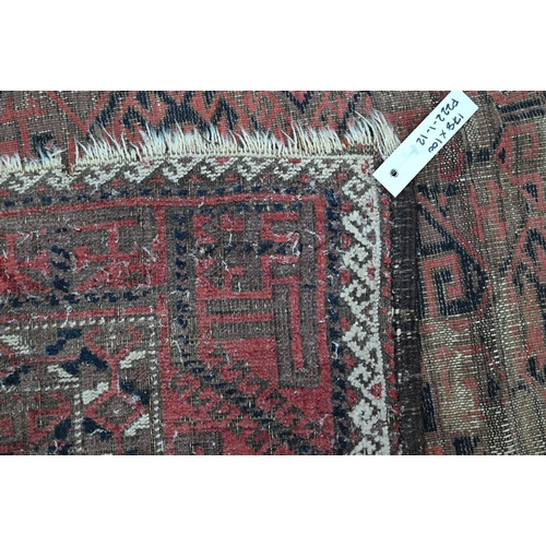 444 - A worn Persian red and brown Balouch rug, 178 x 100 cm