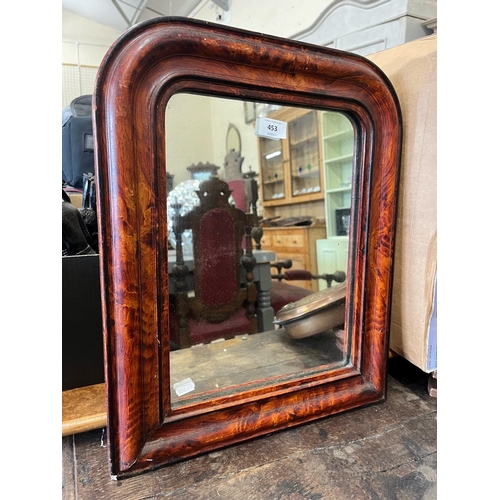 453 - A French wall mirror in moulded simulated tortoiseshell gesso frame, 50 cm high x 42 cm wide