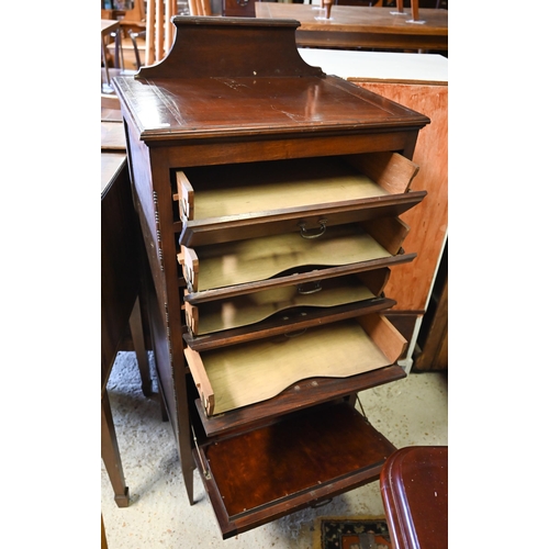 460 - # An Edwardian red walnut part glazed music cabinet with four drawers raised on slender turned legs,... 