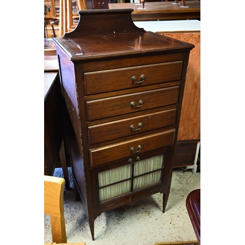 460 - # An Edwardian red walnut part glazed music cabinet with four drawers raised on slender turned legs,... 