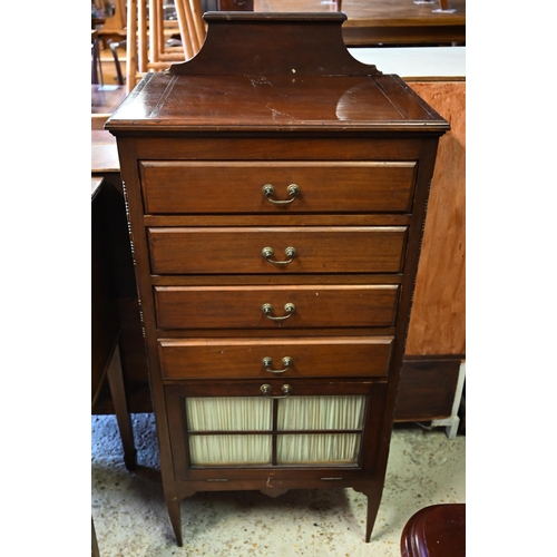 460 - # An Edwardian red walnut part glazed music cabinet with four drawers raised on slender turned legs,... 