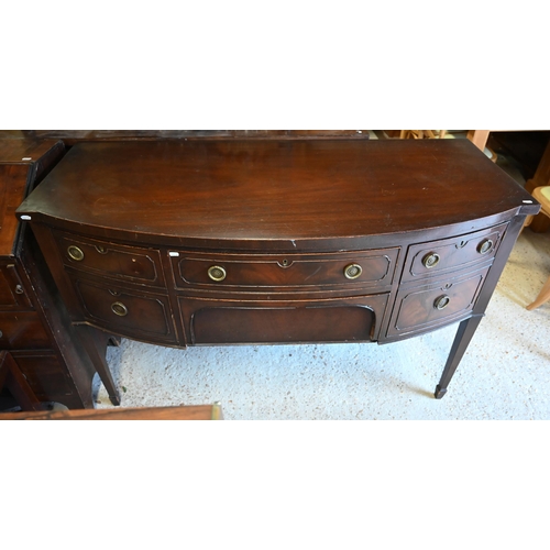 469 - # An old mahogany bowfront sideboard on slender turned legs to brass castors, 137 cm x 63 cm x 90 cm... 