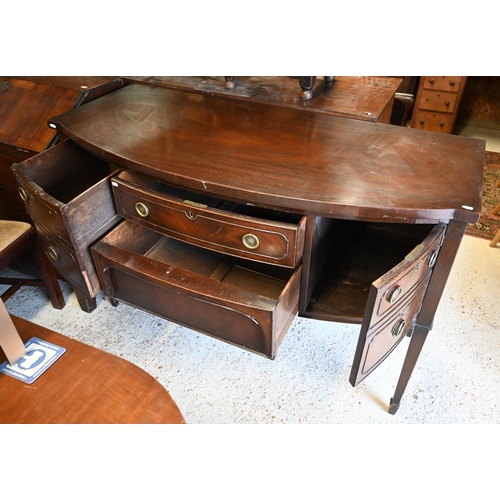 469 - # An old mahogany bowfront sideboard on slender turned legs to brass castors, 137 cm x 63 cm x 90 cm... 