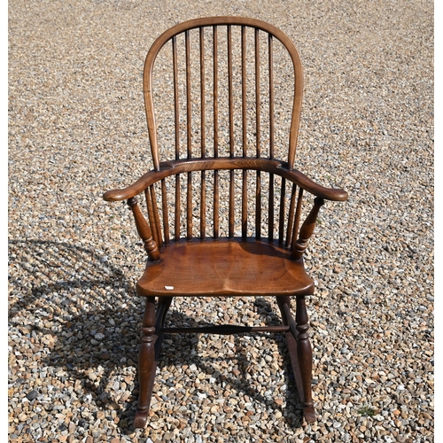 483 - A traditional stained ash and elm stick-back rocking elbow chair