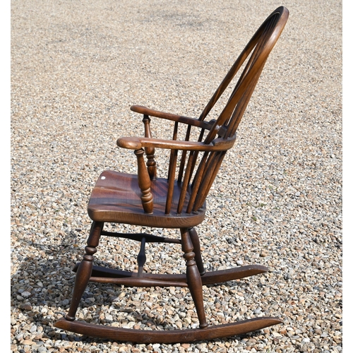 483 - A traditional stained ash and elm stick-back rocking elbow chair