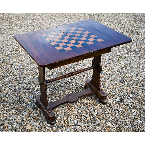 497 - A Victorian mahogany fold over chequerboard top games table, with frieze drawer raised on shaped tre... 