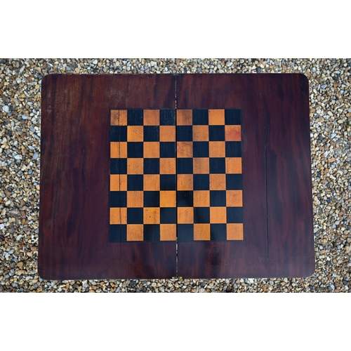 497 - A Victorian mahogany fold over chequerboard top games table, with frieze drawer raised on shaped tre... 