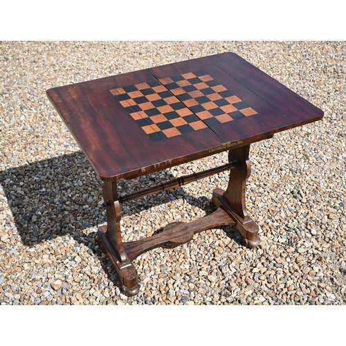 497 - A Victorian mahogany fold over chequerboard top games table, with frieze drawer raised on shaped tre... 