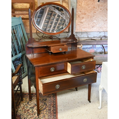 499 - An Edwardian inlaid satinwood oval mirror backed three drawer dressing chest, raised on square legs ... 