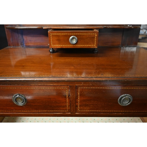 499 - An Edwardian inlaid satinwood oval mirror backed three drawer dressing chest, raised on square legs ... 