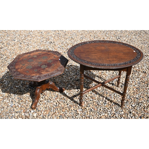 502 - An antique carved and brass inlaid Indian low table on tripod base, 61 x 59 x 43 cm h to/w another w... 