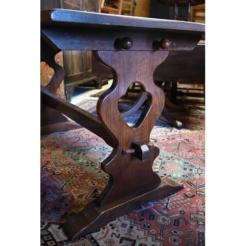 505 - # An oak refectory table raised on shaped trestle ends united by a centre stretcher, 152 x 76 x 75 c... 