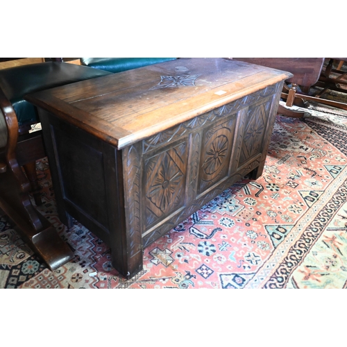 507 - A small carved panelled oak coffer with hinged top, 90 x 45 x 50 cm h