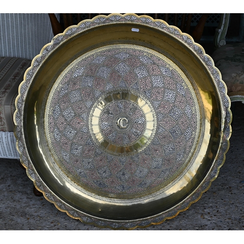 511 - A large chased and engraved brass, white metal and copper circular tray on a carved folding stand, 7... 