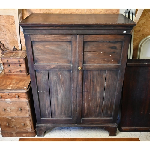 519 - An antique mahogany twin panelled door cupboard/wardrobe, raised on shaped bracket feet, 113 cm x 56... 