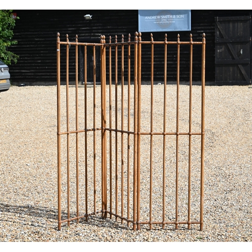 528 - An antique French three fold room divider of pitched pine rods with brass fittings, each panel 60 cm... 