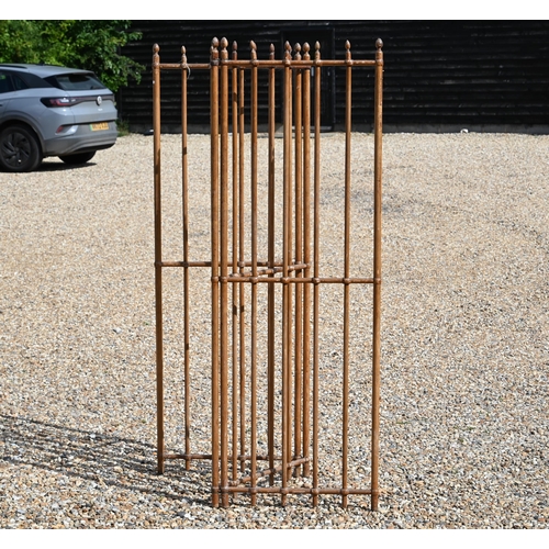 528 - An antique French three fold room divider of pitched pine rods with brass fittings, each panel 60 cm... 