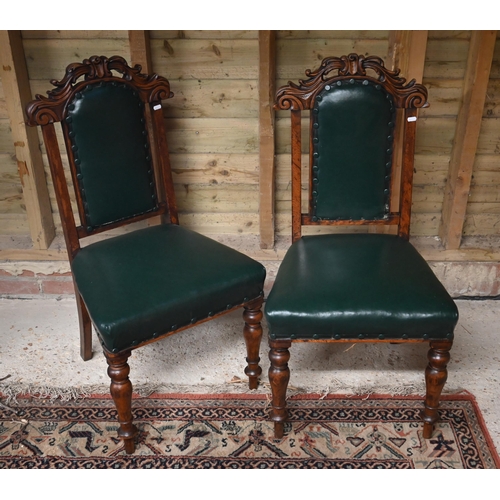 533 - # A pair of carved oak and green leather standard chairs