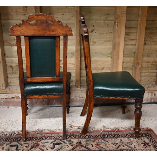 533 - # A pair of carved oak and green leather standard chairs